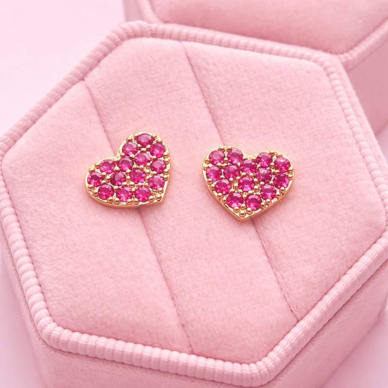 Pink heart stud earrings on a pink jewellery box